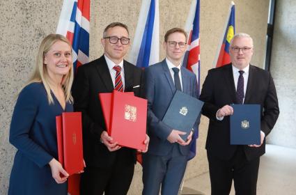 People holding freshly signed MoU's.