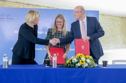 People shaking hands after singing MoU